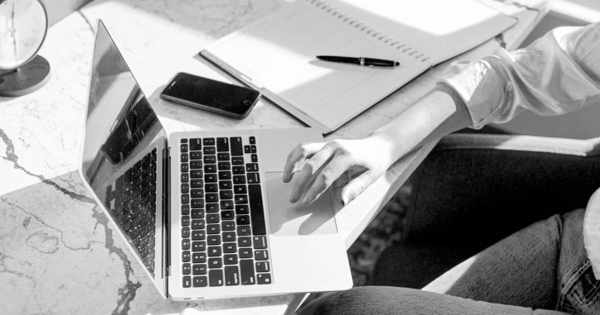 Woman At Desk Using A Laptop