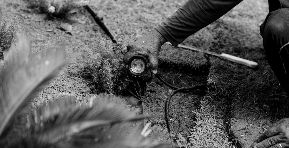 Man Fixing Landscape Lighting