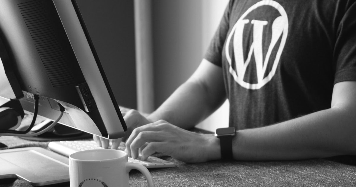 Man Using A Computer With A Wordpress T Shirt