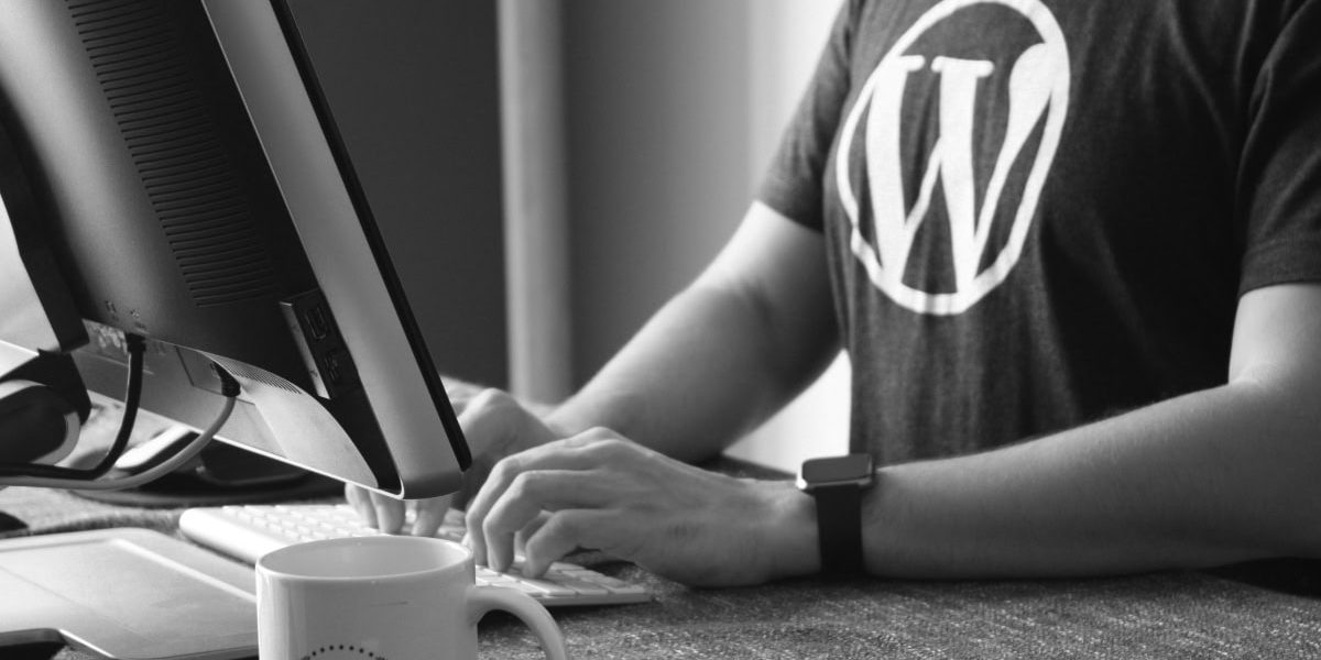 Man Using A Computer With A Wordpress T Shirt