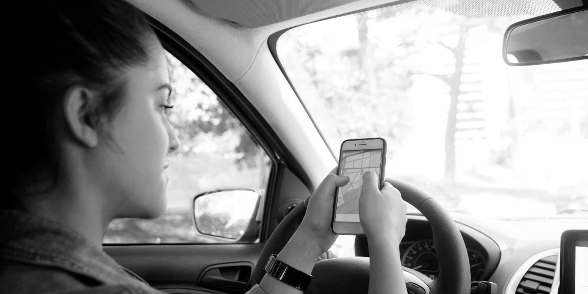 Woman Looking At Google Maps In Car
