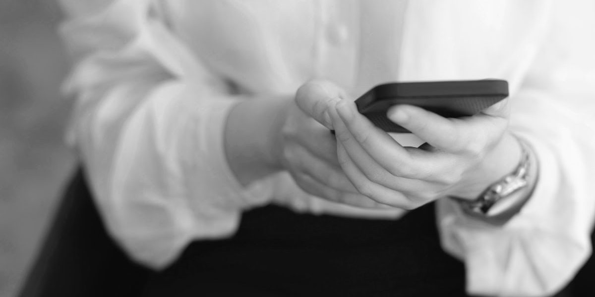 Woman On Cell Phone Writing Google Review