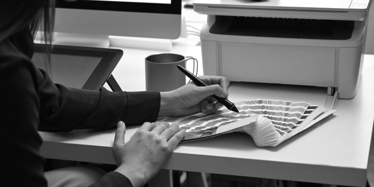Woman Selecting Color From Pantone Book