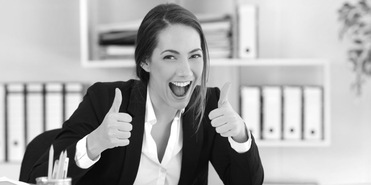 Excited Executive Looking At Camera With Thumbs Up
