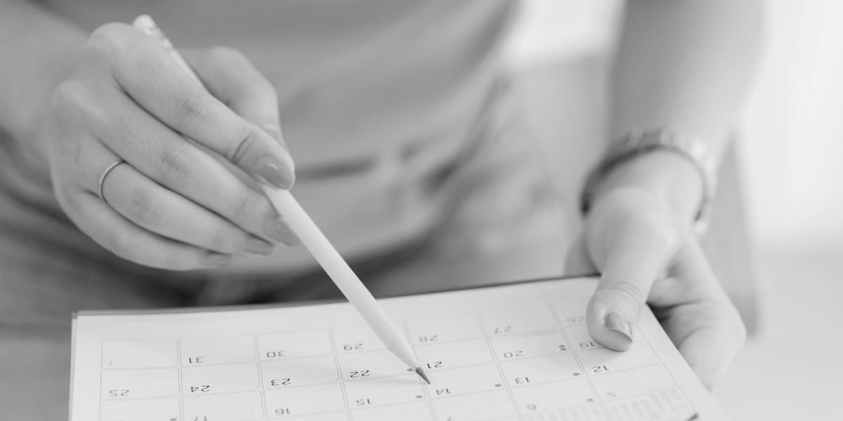 Woman's Hand Using Pen On Calendar