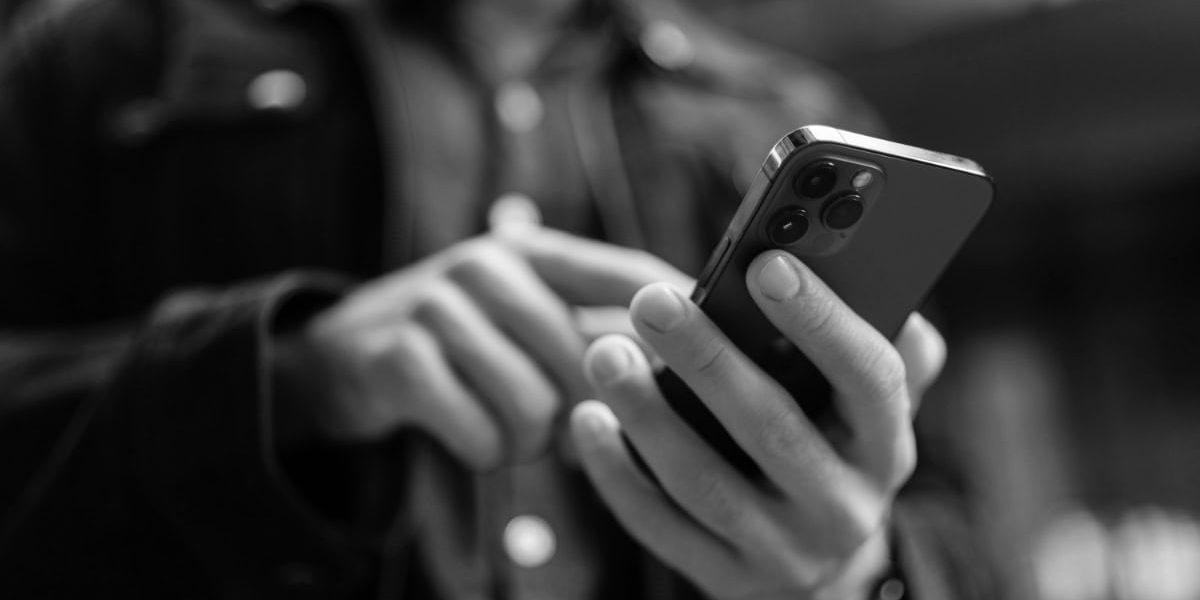 Close Up Hands Of Unrecognizable Man Holding And Using Smartphone Standing On City Street, Browsing Internet, Checking Social Media, Using Mobile Application.