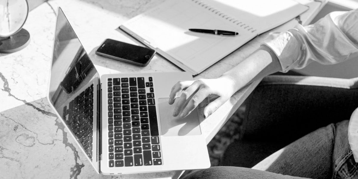 Woman At Desk Using A Laptop